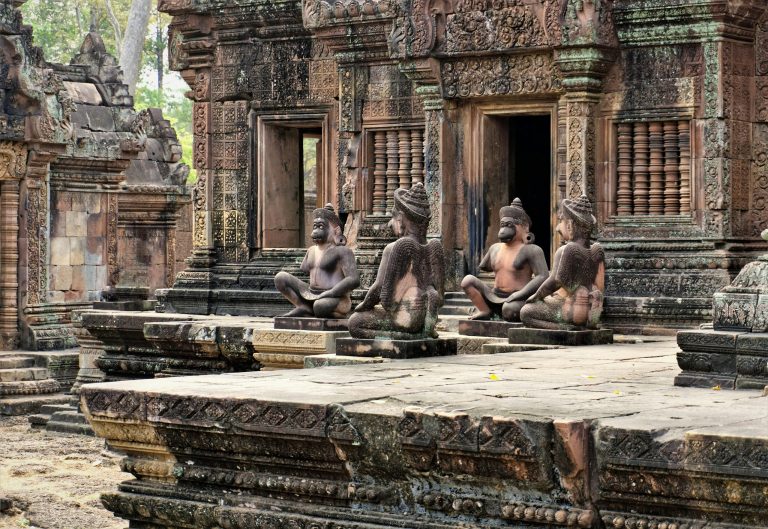 Intricate monkey statues at Banteay Srei in Siem Reap, showcasing ancient Khmer architecture.