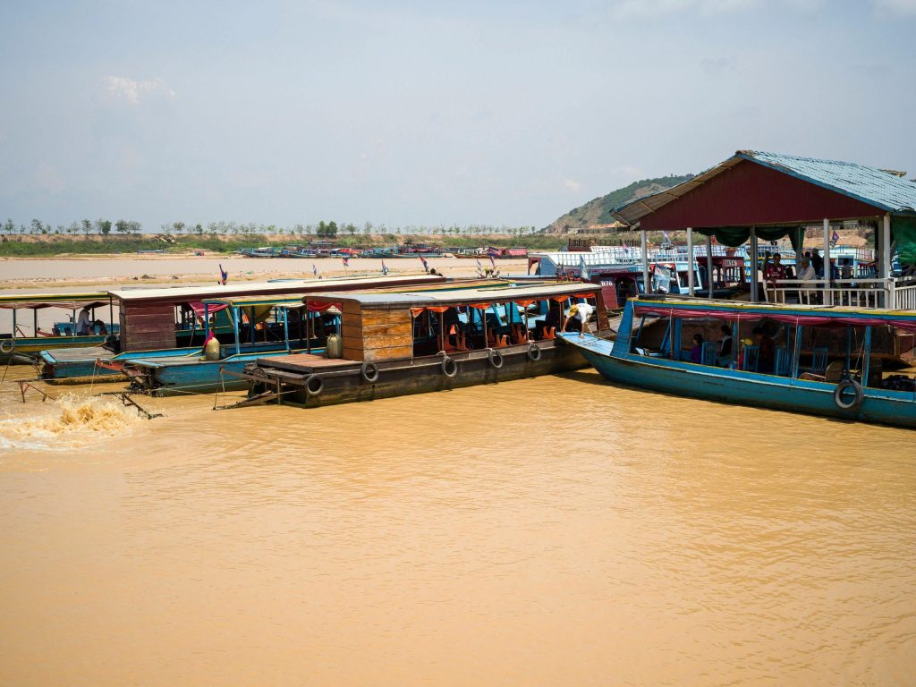 Colorful wooden boats moored along a vibrant riverbank, capturing a slice of local life.